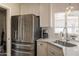 Modern kitchen equipped with stainless steel appliances, undermount sink, white cabinets and marble countertops at 1110 W Heatherbrae Dr, Phoenix, AZ 85013