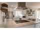 Open-concept kitchen with granite countertops, stainless steel appliances and white cabinets at 1110 W Heatherbrae Dr, Phoenix, AZ 85013