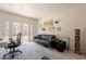 Bright living room with plush carpet, modern sofa, and French doors leading to the outside at 1110 W Heatherbrae Dr, Phoenix, AZ 85013