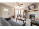 Inviting living room with fireplace, ceiling fan, and ample natural light at 1110 W Heatherbrae Dr, Phoenix, AZ 85013