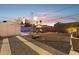 Expansive gravel backyard with shed, lounge seating, fire pit, and cornhole game, great for outdoor entertaining at 1111 E Coronado Rd, Phoenix, AZ 85006