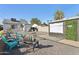 Backyard with outdoor movie screen, lounge seating, mature palm tree, and gravel ground cover at 1111 E Coronado Rd, Phoenix, AZ 85006