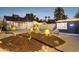 A backyard featuring an outdoor movie screen, garden with cactus, palm trees, and lounge seating at 1111 E Coronado Rd, Phoenix, AZ 85006