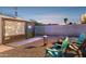 Backyard at dusk with a fire pit and projector movie screen, perfect for outdoor entertaining at 1111 E Coronado Rd, Phoenix, AZ 85006