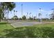 Community basketball court with multiple hoops, surrounded by trees, offering recreational opportunities for residents at 1111 E Coronado Rd, Phoenix, AZ 85006