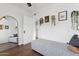 Bedroom with a stylish bench, large mirror, and views into other rooms at 1111 E Coronado Rd, Phoenix, AZ 85006