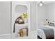 Charming bedroom niche with vintage telephone, books, and a view into the bedroom at 1111 E Coronado Rd, Phoenix, AZ 85006