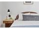 Bedroom features wood headboard, stylish lamp on wooden nightstand at 1111 E Coronado Rd, Phoenix, AZ 85006
