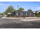 A modern commercial building featuring outdoor patio seating with striped umbrellas and stylish design elements at 1111 E Coronado Rd, Phoenix, AZ 85006