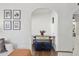 Dining area showcasing an arched doorway, neutral walls and decor, and hardwood flooring at 1111 E Coronado Rd, Phoenix, AZ 85006