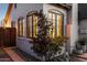 Classic white brick home exterior with arched windows, lush landscaping, and stone accents at 1111 E Coronado Rd, Phoenix, AZ 85006