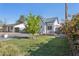 Beautiful home featuring a lush green lawn, mature trees, and inviting outdoor seating area at 1111 E Coronado Rd, Phoenix, AZ 85006