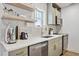 Modern kitchen features light green cabinetry, sleek stainless steel appliances, and bright, white countertops at 1111 E Coronado Rd, Phoenix, AZ 85006