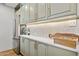 Kitchen showcases white countertops, light green cabinetry with gold hardware, and stainless steel appliances at 1111 E Coronado Rd, Phoenix, AZ 85006