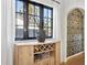Chic living space features a large window, adjacent dining area, and an elegant dry bar with a wine rack at 1111 E Coronado Rd, Phoenix, AZ 85006