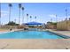 Large outdoor community pool with shaded seating area, palm trees, and clear blue water for relaxing swims at 1111 E Coronado Rd, Phoenix, AZ 85006