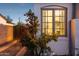Window box with blooming roses with a view to the neutral interior lighting of this bright, stylish home at 1111 E Coronado Rd, Phoenix, AZ 85006