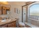 Well-appointed bathroom featuring a stone vanity and a glass-enclosed shower with tile surround at 11550 E Paradise Ln, Scottsdale, AZ 85255