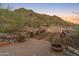 Charming wooden bridge with lantern lighting leading through the desert landscape at 11550 E Paradise Ln, Scottsdale, AZ 85255