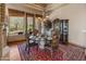 Bright dining room with a glass table, elegant chairs, and large windows offering natural light at 11550 E Paradise Ln, Scottsdale, AZ 85255