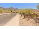 A welcoming sign for One Hundred Hills is landscaped with native desert plants at 11550 E Paradise Ln, Scottsdale, AZ 85255
