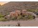 Stunning hillside home with a terracotta roof, desert landscaping, and a brick driveway at 11550 E Paradise Ln, Scottsdale, AZ 85255