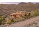 This beautiful hillside home has a covered patio, pool, and desert landscaping at 11550 E Paradise Ln, Scottsdale, AZ 85255
