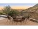 This cozy outdoor fire pit and desert views create a perfect setting for relaxation and socializing at 11550 E Paradise Ln, Scottsdale, AZ 85255