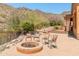 A backyard fire pit is surrounded by seating with desert views at 11550 E Paradise Ln, Scottsdale, AZ 85255