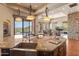 Open-concept kitchen with an island overlooking the living area and outdoor pool at 11550 E Paradise Ln, Scottsdale, AZ 85255