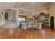 Spacious kitchen with stone countertops, stainless steel appliances, and hardwood floors at 11550 E Paradise Ln, Scottsdale, AZ 85255