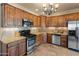 Well-equipped kitchen with stainless steel appliances, granite countertops, and custom wood cabinetry at 11550 E Paradise Ln, Scottsdale, AZ 85255