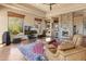 Inviting living room with a stone fireplace, hardwood floors, and scenic views at 11550 E Paradise Ln, Scottsdale, AZ 85255