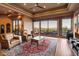 Spacious living room featuring hardwood floors, large windows with mountain views, and a comfortable seating area at 11550 E Paradise Ln, Scottsdale, AZ 85255