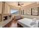 Inviting bedroom with a fireplace, hardwood floors, mountain views and abundant natural light at 11550 E Paradise Ln, Scottsdale, AZ 85255
