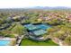 Aerial view of the community pickleball courts, walking paths, lush green lawn and Gathering playground in McDowell Mountain Ranch at 11550 E Paradise Ln, Scottsdale, AZ 85255
