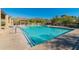 Heated community pool with lounge chairs, tables and mountain views at 11550 E Paradise Ln, Scottsdale, AZ 85255
