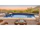 Sparkling pool with a vanishing edge, surrounded by desert landscaping and scenic views, perfect for relaxation at 11550 E Paradise Ln, Scottsdale, AZ 85255