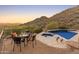 Relaxing pool area with patio seating and scenic views of the surrounding desert landscape at 11550 E Paradise Ln, Scottsdale, AZ 85255