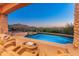 Backyard pool, spa, and patio feature stunning sunset and mountain views at 11550 E Paradise Ln, Scottsdale, AZ 85255