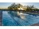 Enjoy the community lap pool with marked lanes, lounge chairs and mature trees in a scenic desert setting at 11550 E Paradise Ln, Scottsdale, AZ 85255