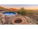 Beautiful pool and firepit area with desert landscaping and mountain views at 11550 E Paradise Ln, Scottsdale, AZ 85255