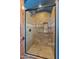 Tile shower with dark trim and hardware at 11550 E Paradise Ln, Scottsdale, AZ 85255