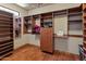 Spacious walk-in closet with custom shelving, drawers, and ample hanging space at 11550 E Paradise Ln, Scottsdale, AZ 85255