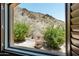 Picturesque window view overlooking desert landscaping and mountains at 11550 E Paradise Ln, Scottsdale, AZ 85255