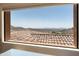 Scenic window view highlighting the red tile roofs and distant mountains at 11550 E Paradise Ln, Scottsdale, AZ 85255
