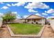 Lovely backyard featuring a covered patio and lush green lawn, perfect for outdoor living at 13137 W Wilshire Dr, Goodyear, AZ 85395