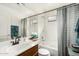 Updated bathroom with soaking tub, wood cabinets, and stylish fixtures at 13137 W Wilshire Dr, Goodyear, AZ 85395