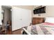Bedroom with sliding closet doors, window and rustic furniture at 13137 W Wilshire Dr, Goodyear, AZ 85395