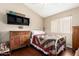 Bedroom with window, ceiling fan, and rustic furniture at 13137 W Wilshire Dr, Goodyear, AZ 85395